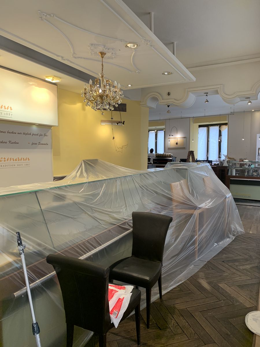 Theke und Vitrine unter Malerfolie, Stühle beiseitegeräumt